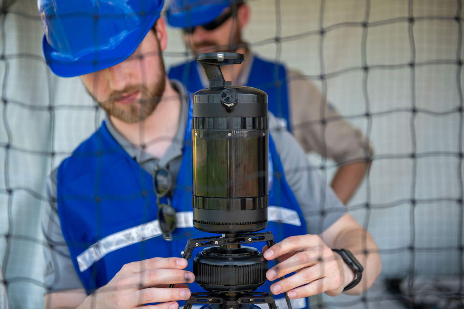 Team member adjusting his UAV prior to practice run