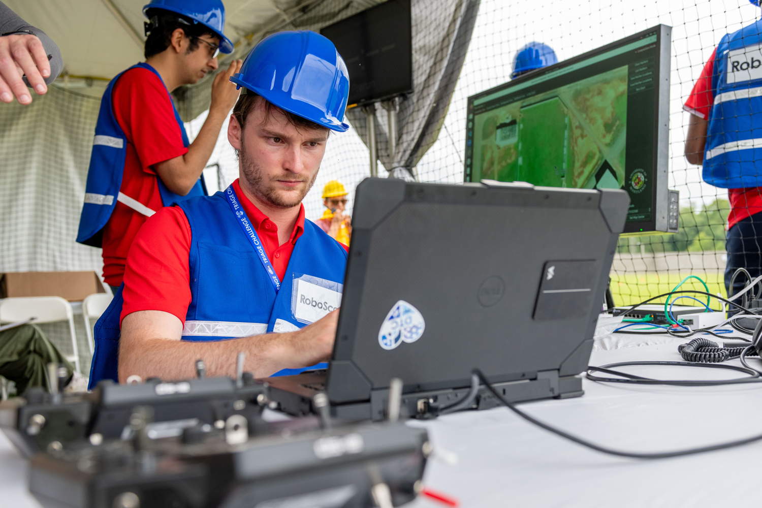 RoboScout team members on practice run (DTC sticker on computer)