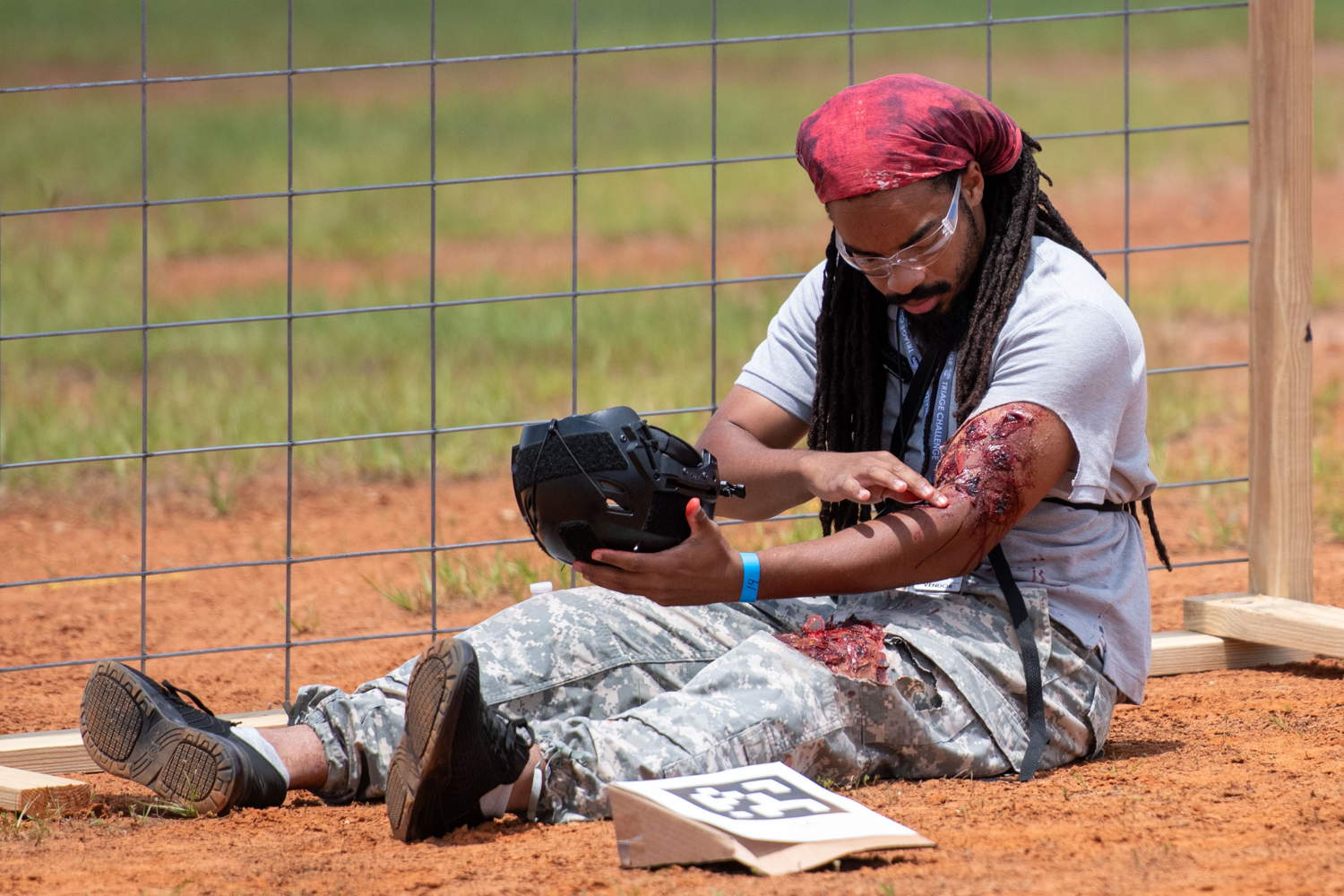 Actor examining moulage wounds