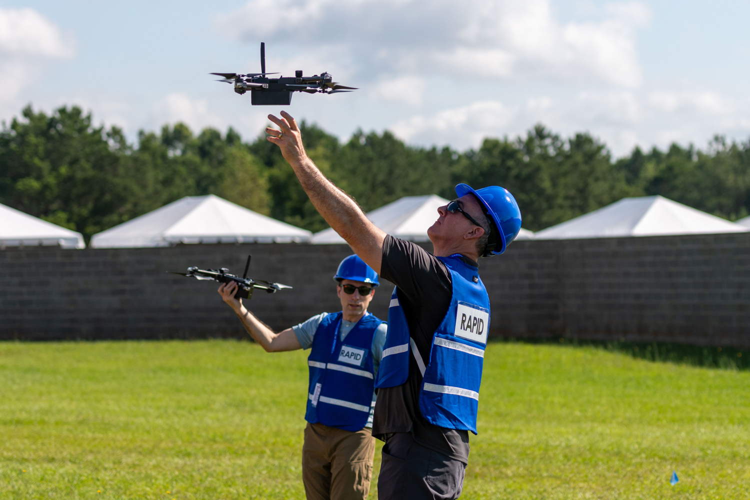 Two RAPID team members launch UAVs